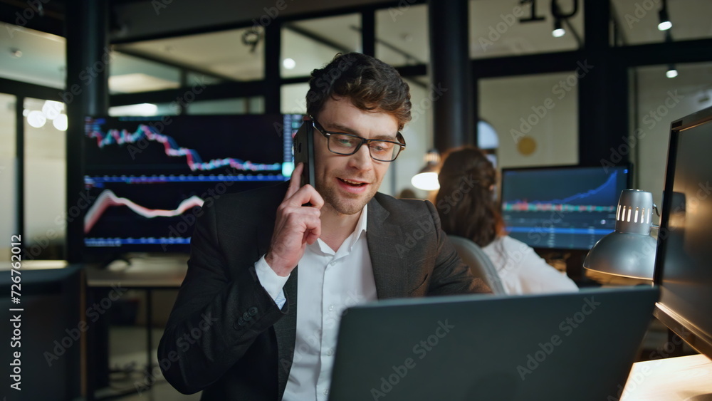 Smiling businessman talking smartphone at investment graph. Successful salesman Smiling businessman talking smartphone at investment graph. Successful salesman