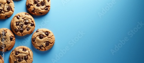 White packaged chocolate chip cookies on blue background with top view and empty space.
