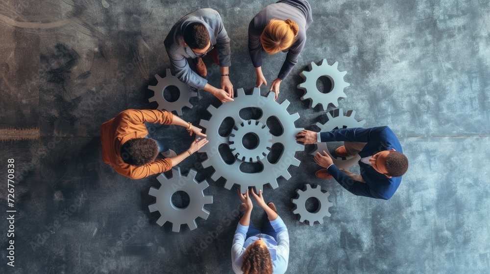 Teamwork of business people work together and combine pieces of gears Teamwork of business people work together and combine pieces of gears