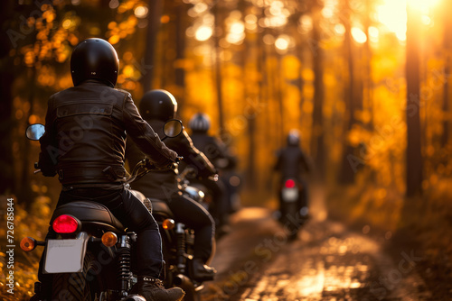 group of motorcyclists riding through a forest at sunset. The riders are wearing helmets and leather jackets, and there are trees and foliage in the background