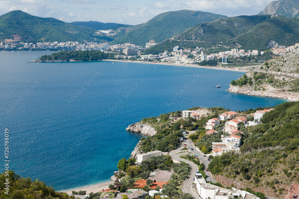 Top view of Budva riviera on a sunny day, Montenegro. Coast background for publication, design, poster, calendar, post, screensaver, wallpaper, cover, website. High quality photo