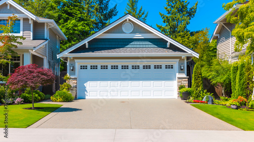 Garage door background. A typical American white garage door with a driveway in front photo