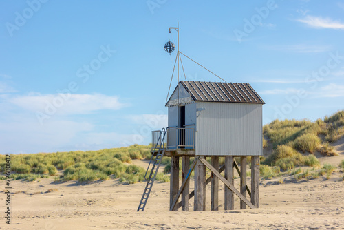 A wooden shelter on high stilts that stands on the North Sea beach (De Drenkelingenhuisje) The Dutch Wadden Sea island Terschelling, Municipality and an island in the northern, Friesland, Netherlands. photo