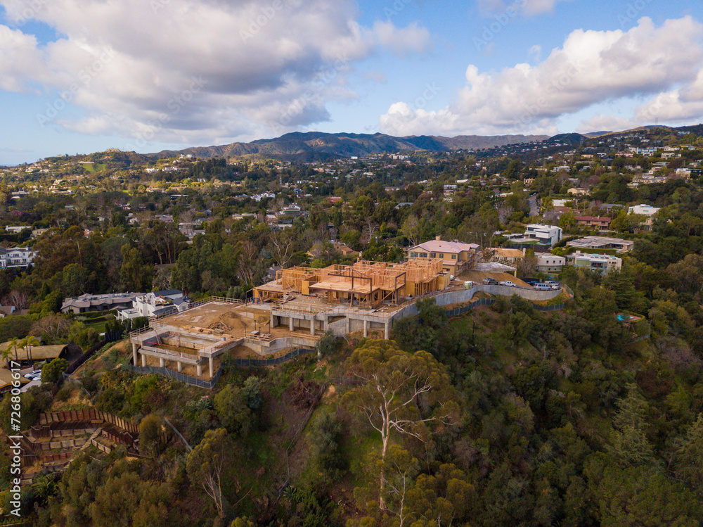 Aerial views of a very large mansion, on a hilltop in the affluent Brentwood neighborhood, under construction.