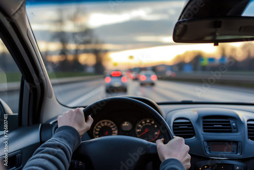 person driving a car on a highway with a steering wheel and a radio photo