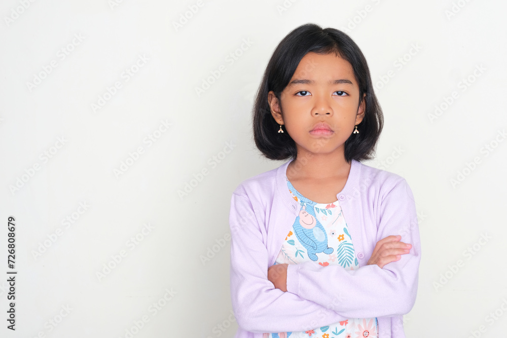Asian kid showing mad expression with arms crossed Asian kid showing mad expression with arms crossed