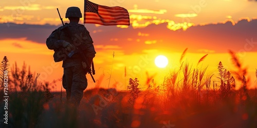 Silhouette of a soldier at sunset with American Flag