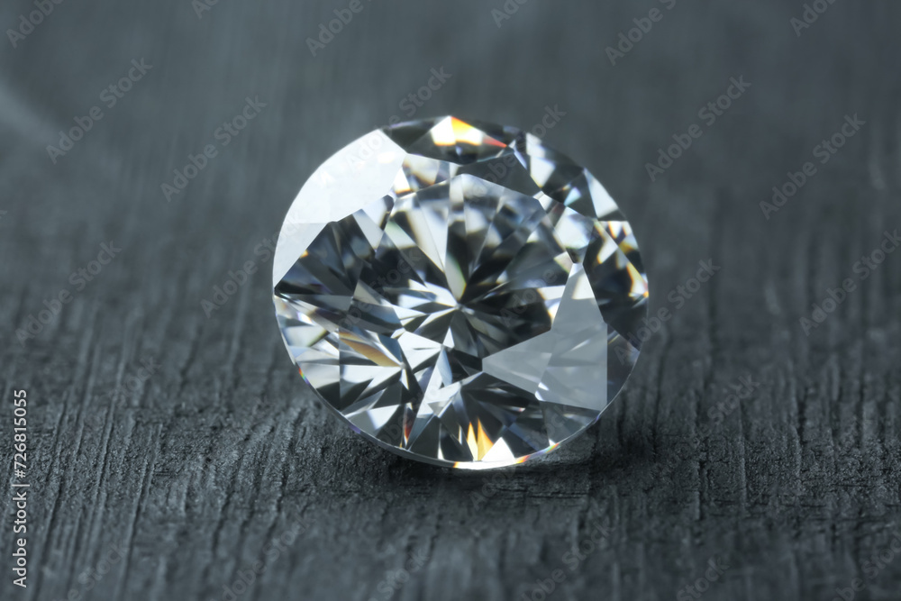 Beautiful shiny diamond on dark gray table, closeup Beautiful shiny diamond on dark gray table, closeup