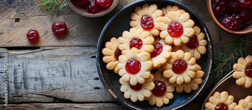 Vintage table top with homemade red jam-filled jelly cookies. photo