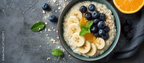 A bowl for text containing breakfast with Milk rice porridge, bananas, blueberry and orange jam, and creamy rice pudding or French riz au lait. photo