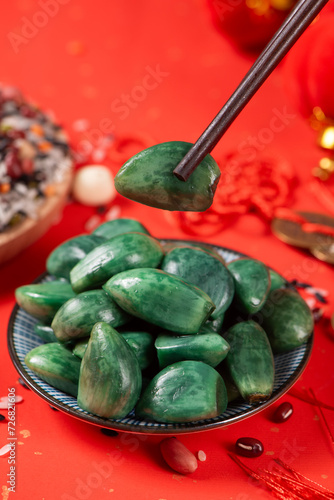traditional Chinese food Laba garlic pickled garlic on red paper background.