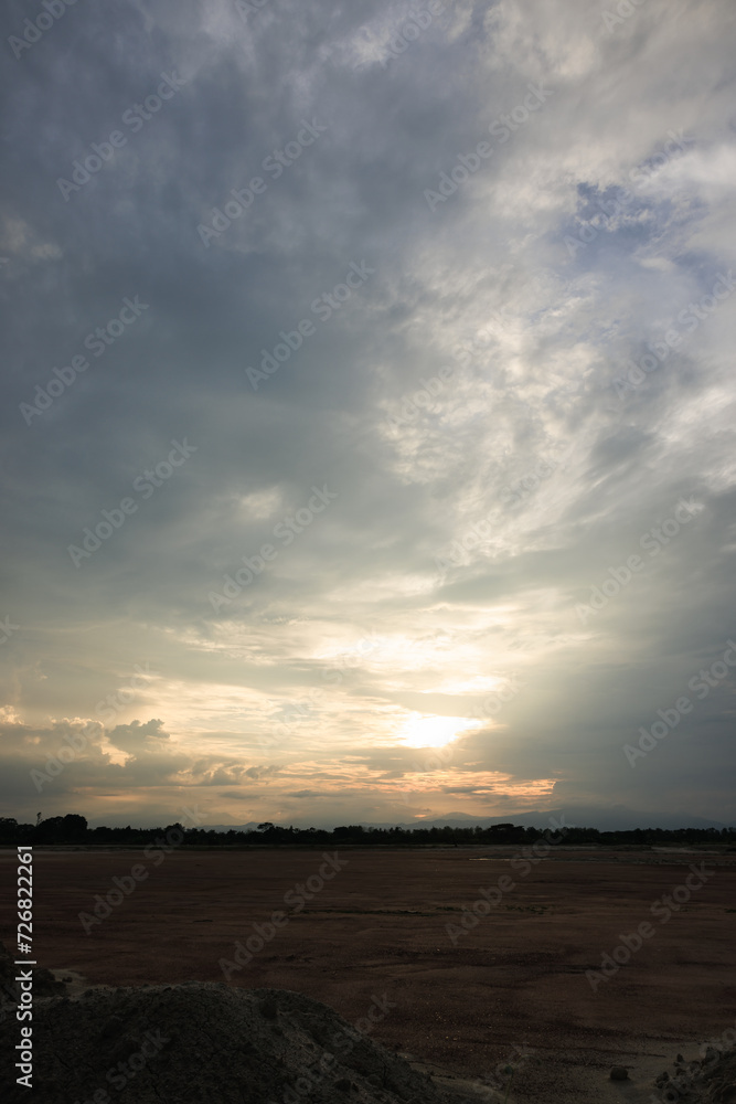 Sky during overcast, storm at evening. Include many gray clouds, empty space, light nature, sunset sunrise, horizon skyline, land or landscape at outdoor for background. Concept of disaster, danger.