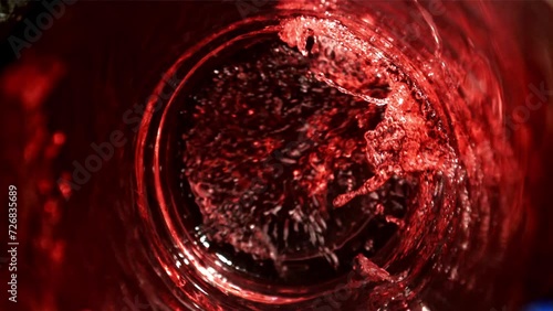 Red wine is poured into a glass. Top view. Filmed on a high-speed camera at 1000 fps. High quality FullHD footage photo