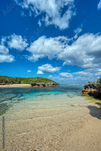 Crystal clear waters of Bise Beach  Motobu District  Okinawa main island. White sand beach with coral outcrops and small islands offshore