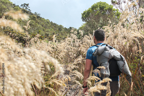 Guy hiking on a paramo surrounded by nature photo