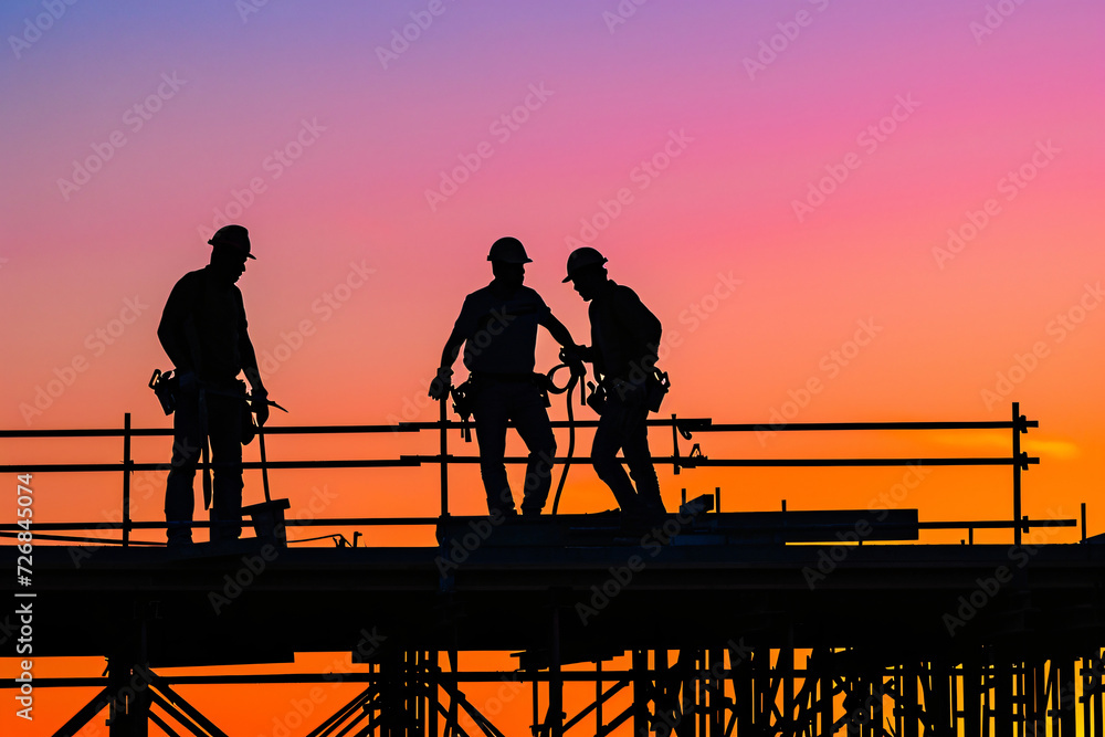 Obraz premium photo construction workers at sunset