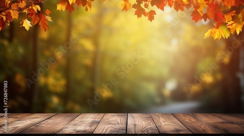 a wooden table with a blurred autumn background and a place for text.