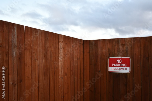 Wooden fence with no parking sign.
