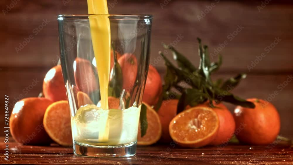 Fresh tangerine juice is poured into a glass. Filmed on a high-speed camera at 1000 fps. High quality FullHD footage Fresh tangerine juice is poured into a glass. Filmed on a high-speed camera at 1000 fps. High quality FullHD footage