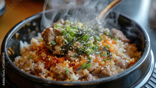 Korean Bulgogi Pork Rice on top with onsen york with someone put spoon in, hot steaming looking moist and very delicious
