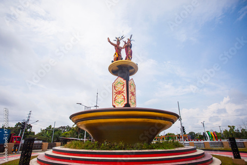Mahir Mahar Monument, a monument honoring the local hero of Palangkaraya. The monument depicts a pair of traditional dancers with various ornaments typical of Central Kalimantan, Indonesia. photo
