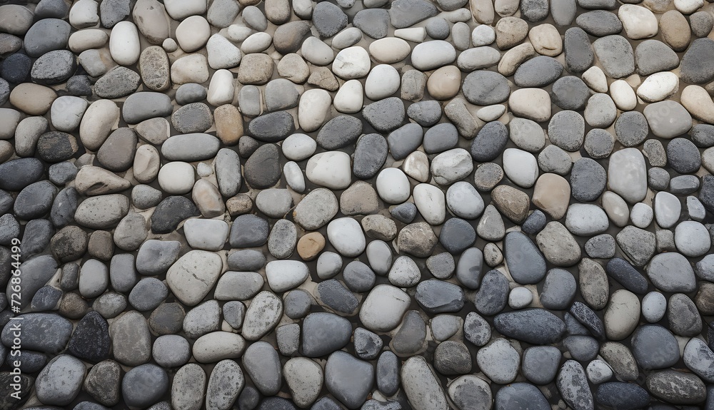 A wall background evenly paved with gray stones. A wall background evenly paved with gray stones.