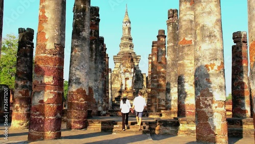 Sukhothai Old City, Thailand. Ancient city and culture of South Asia Thailand, Sukhothai Historical Park,Couple of men and women visit Wat Mahathat, Sukhothai's old historical city in Thailand. photo