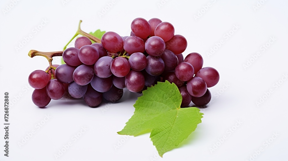 Fototapeta premium bunch of red grapes with green leaf isolated on a white background
