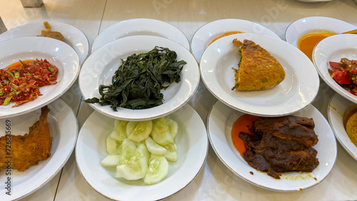 A line plate of various padang cuisine. One of the most popular meals in Indonesia, a mix of rice and side dishes originally from Padang, Indonesia.