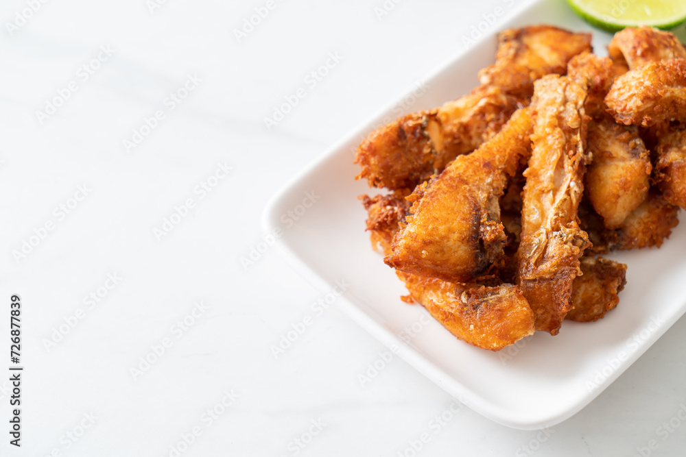 Fried Snapper Belly on white plate Fried Snapper Belly on white plate