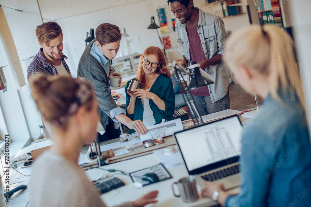 Obraz premium Diverse group of young designers working in an office