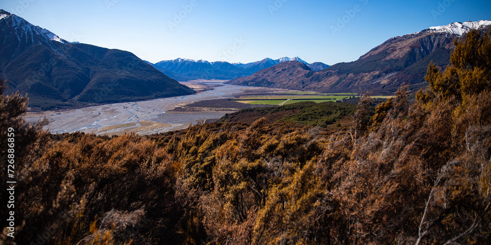 spring panorama of mountains in artur's pass national park, canterbury, new zealand; waimakariri river valley surrounded with massive, snow-capped mountains seen from bealey spur track
