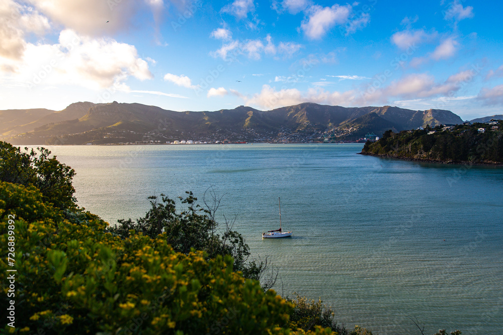 scenic, colorful sunset over church bay in banks peninsula, canterbury, new zealand south island