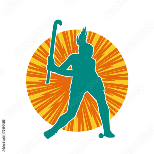 Silhouette of female field hockey athlete in action. Silhouette of a woman playing field hockey sport.
