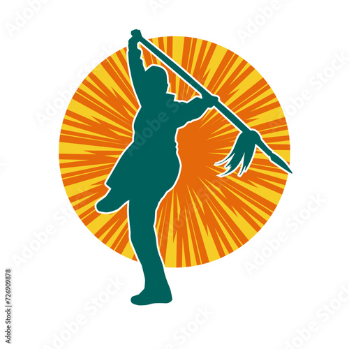 Silhouette of a wushu martial artist in action pose with a spear weapon. Silhouette of a fighter carrying a spear weapon.