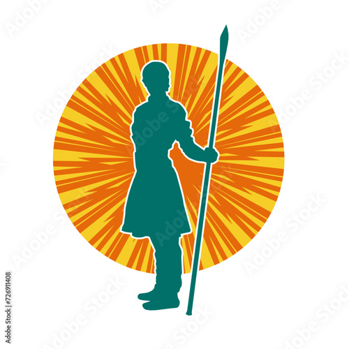 Silhouette of a wushu martial artist in action pose with a spear weapon. Silhouette of a fighter carrying a spear weapon.