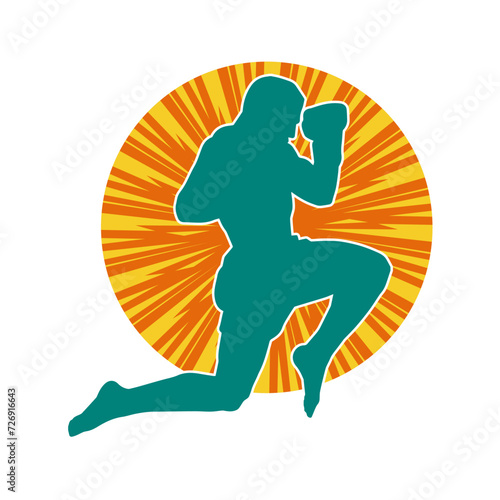 Silhouette of a kickboxer athlete in action pose. Silhouette of a sporty man doing kicking pose.

