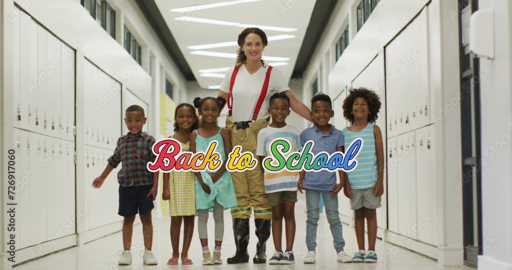Image of back to school text in rainbow colours over happy diverse ...