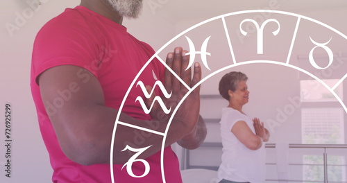 Image of horoscope over senior african american couple exercising