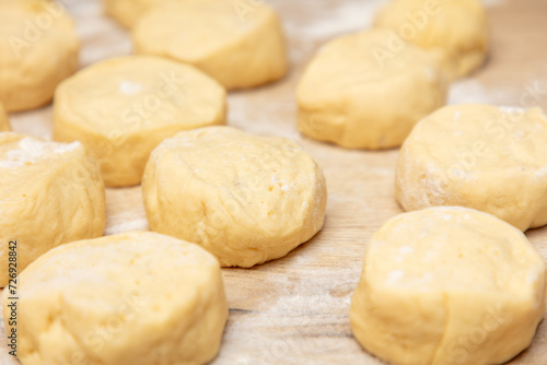 Pieces of dough on the table in flour.