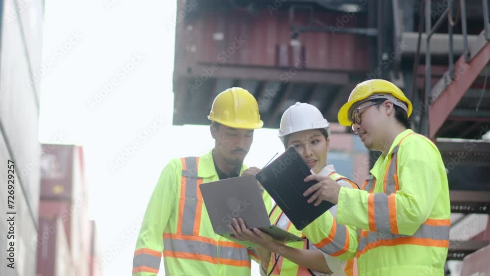 Group of professional dock worker and engineer taking with their supervisor while record data online with digital tablet and laptop at container cargo, happy that the work was successfully completed Group of professional dock worker and engineer taking with their supervisor while record data online with digital tablet and laptop at container cargo, happy that the work was successfully completed
