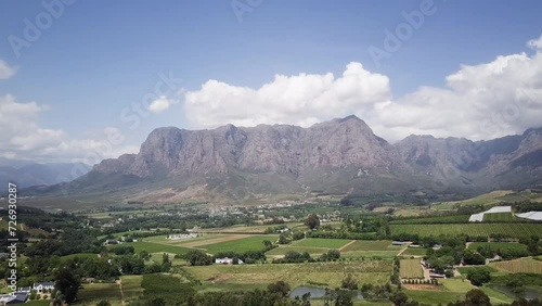 Massive Rock Mountains Down The Countryside Town And Vineyards In Constantia, Cape Town, South Africa. Aerial Wide Shot photo