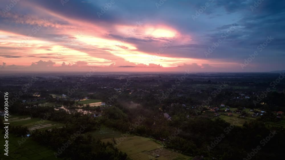 Hyperlapse timelapse of sunset with bright and colorful sky over Indonesian Ubud village, Bali. Aerial forward