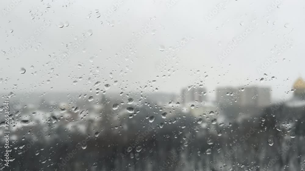 Snowstorm on the street and drops of water on the window glass. Snowstorm on the street and drops of water on the window glass.
