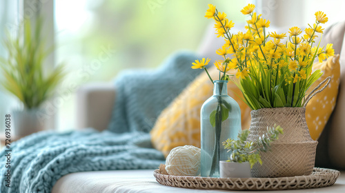 Closeup of yellow spring flowers in vases inside a clean living room space.