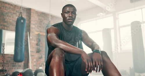 Fitness, gym and face of tired black man breathing after training, workout or intense exercise. Health, portrait or African bodybuilder sweating at sports center for athlete, resilience or challenge photo