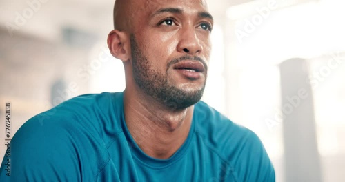 Exercise, sweating and breathing with man in gym to rest from workout for health or cardio. Fitness, tired and intensity with face of exhausted young athlete training for performance or improvement photo