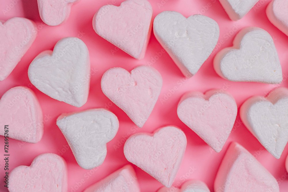 Pink marshmelow hearts on a pink background. The concept of Valentine's Day. February 14