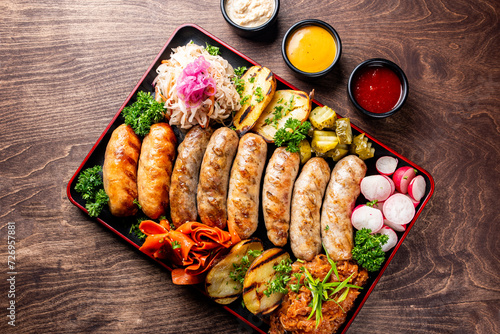 fast food set on plate. various meat Bavarian, Frankfurt, German grilled sausages and vegetables