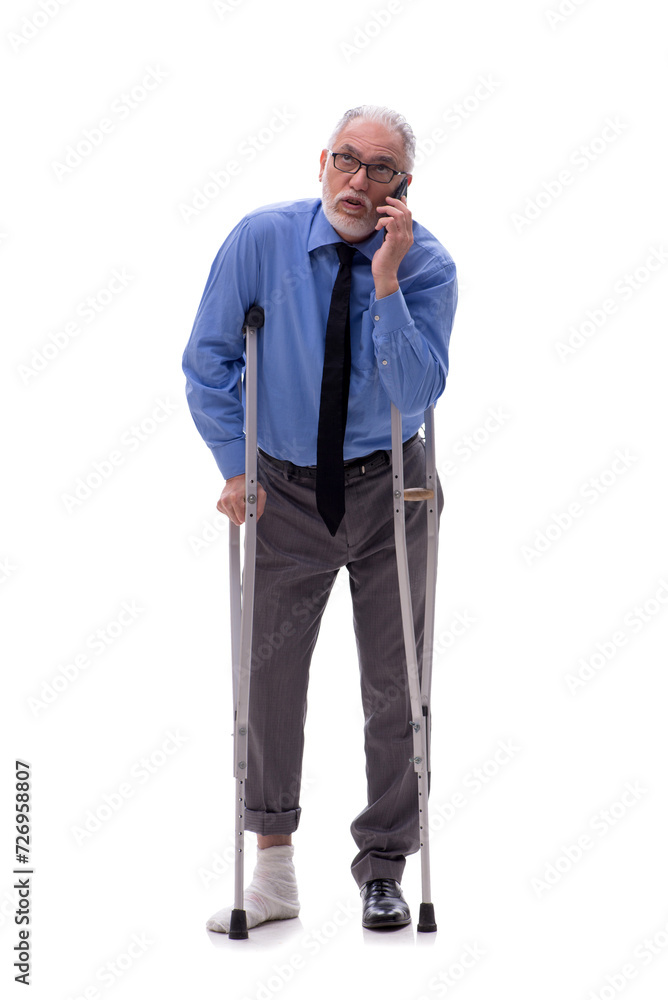 Old businessman with crutches isolated on white Old businessman with crutches isolated on white